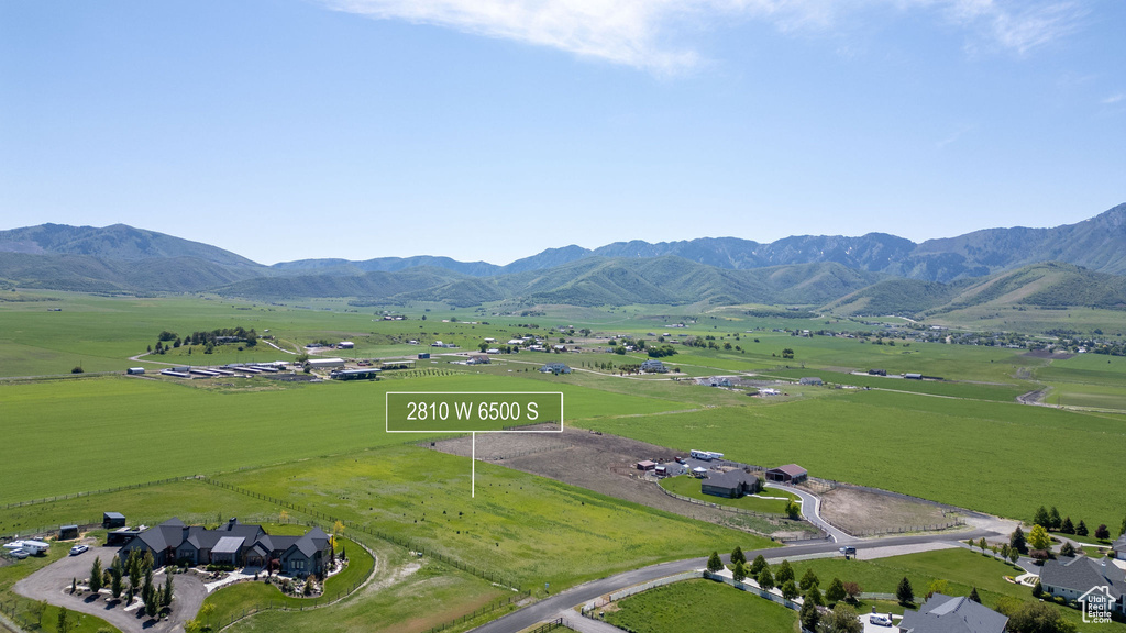 Overview of rural landscape featuring agricultural land and a mountain backdrop