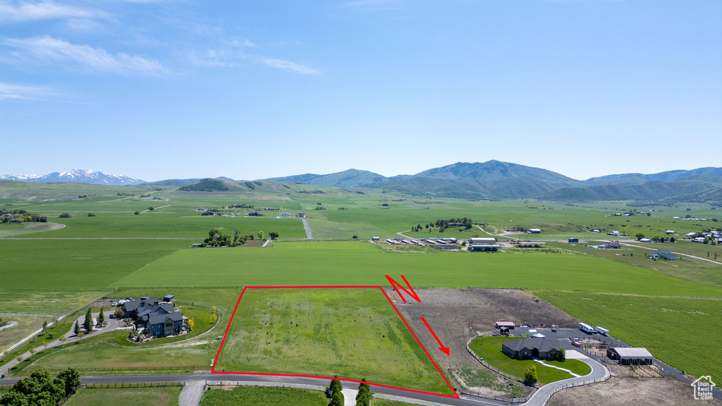 Overview of rural landscape with property boundaries highlighted and a mountainous background