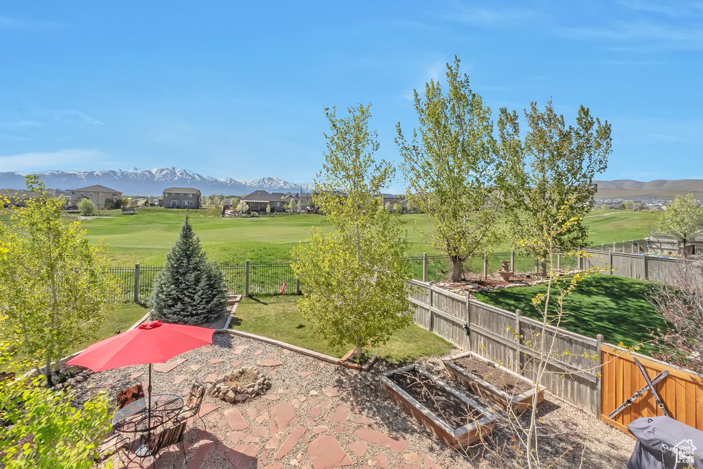 View of yard with a vegetable garden, a fenced backyard, and a mountain view