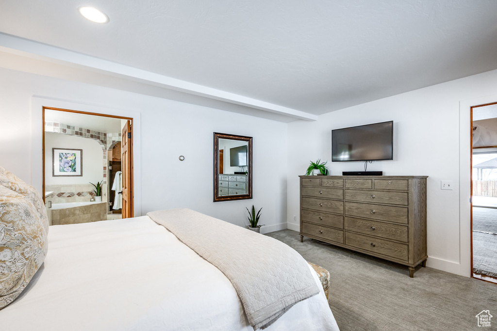 Bedroom with baseboards, recessed lighting, ensuite bath, and light colored carpet