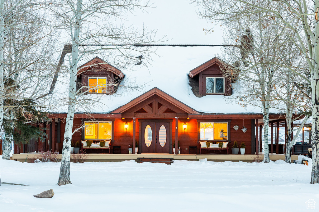 Rustic home with a porch and a chimney
