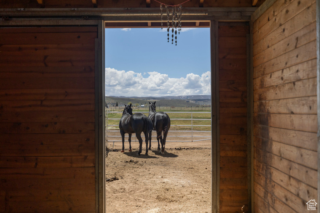 View of horse barn featuring a rural view