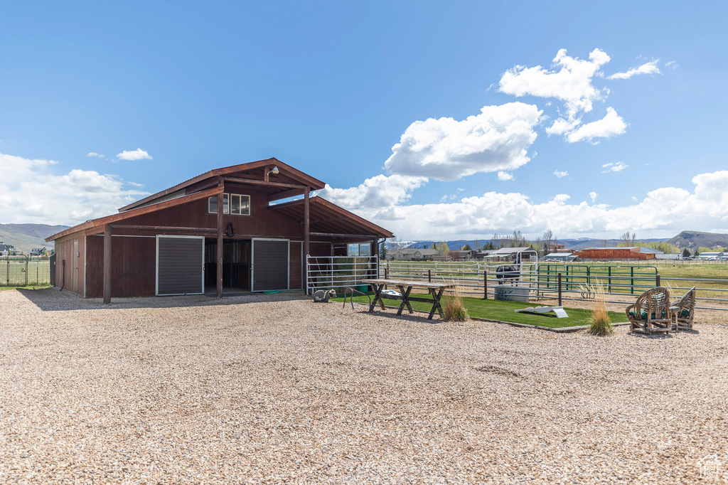 View of horse barn with a mountain view