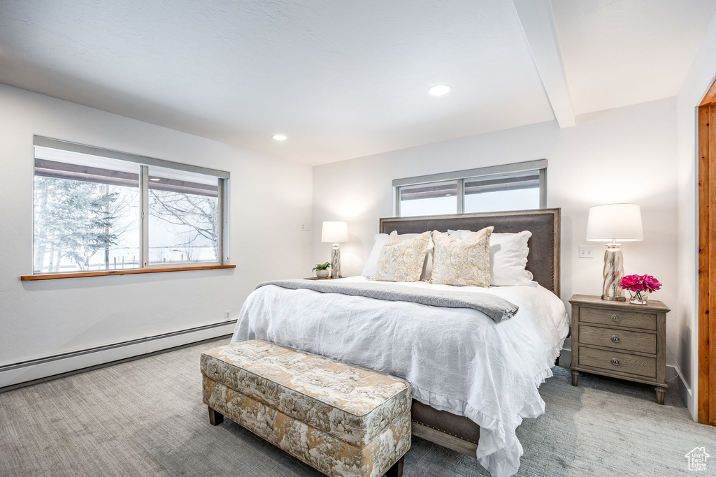 Bedroom featuring carpet floors, baseboard heating, recessed lighting, and beam ceiling