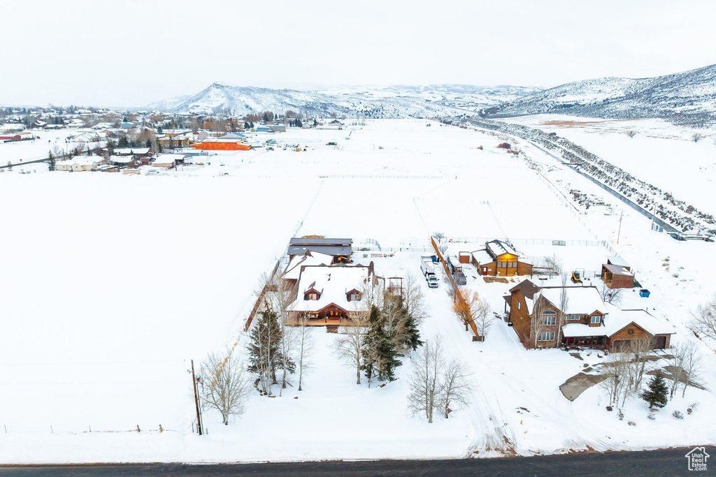 Snowy aerial view featuring a residential view and a mountain view
