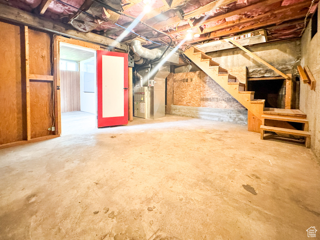 Basement with stairs and heating unit