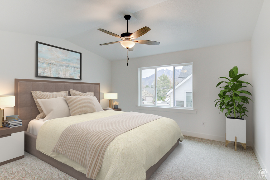Bedroom featuring a ceiling fan, light carpet, vaulted ceiling, and baseboards