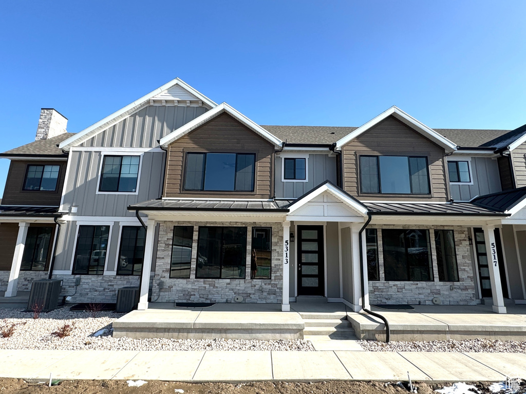 View of front of property with board and batten siding, a standing seam roof, and covered porch