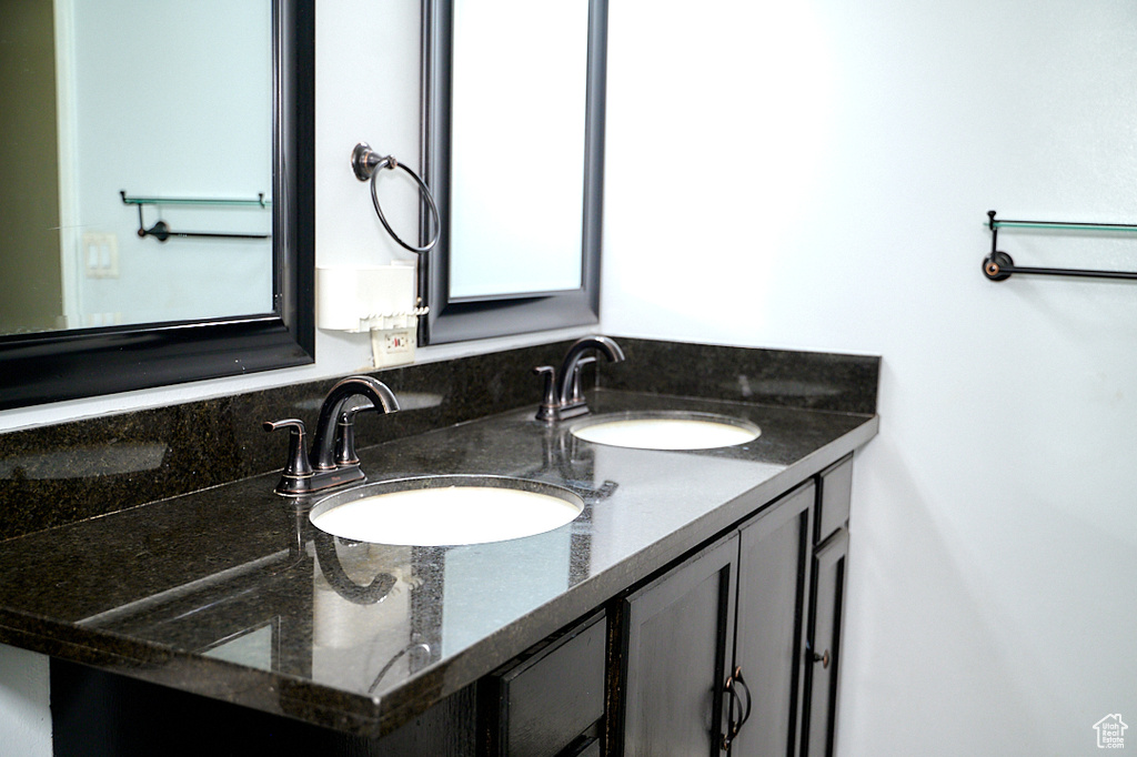 Bathroom featuring double vanity and a sink