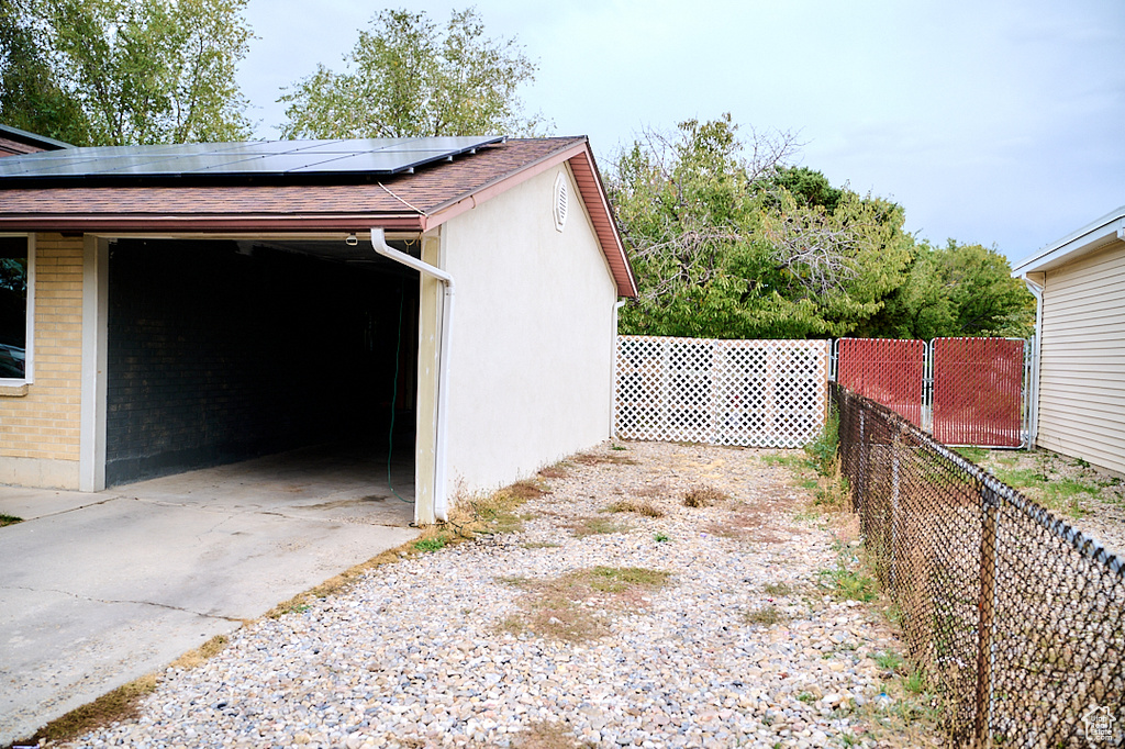 Garage with fence and roof mounted solar panels