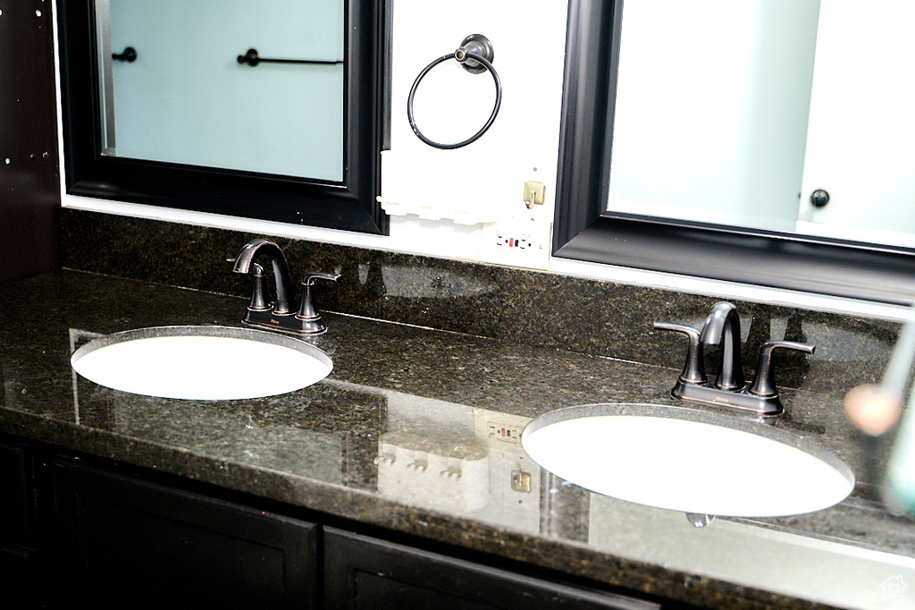 Bathroom featuring tasteful backsplash and vanity