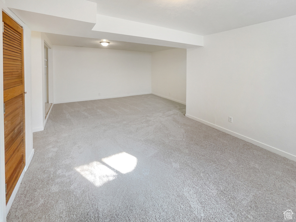 Finished below grade area with baseboards and carpet floors