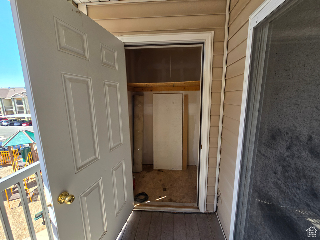 Hall featuring wooden walls and wood finished floors