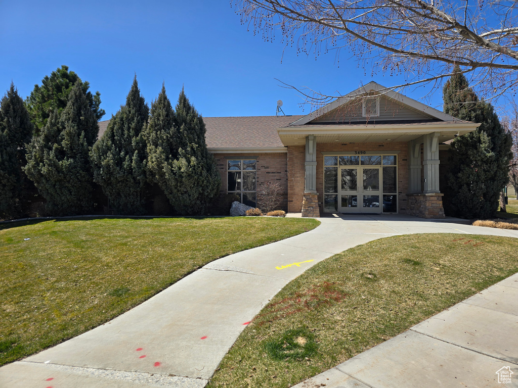 View of front of property with brick siding and a front lawn