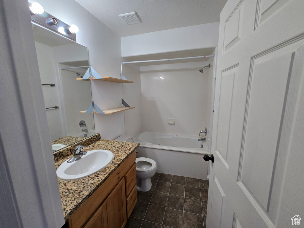 Bathroom featuring visible vents, toilet, tub / shower combination, vanity, and tile patterned floors