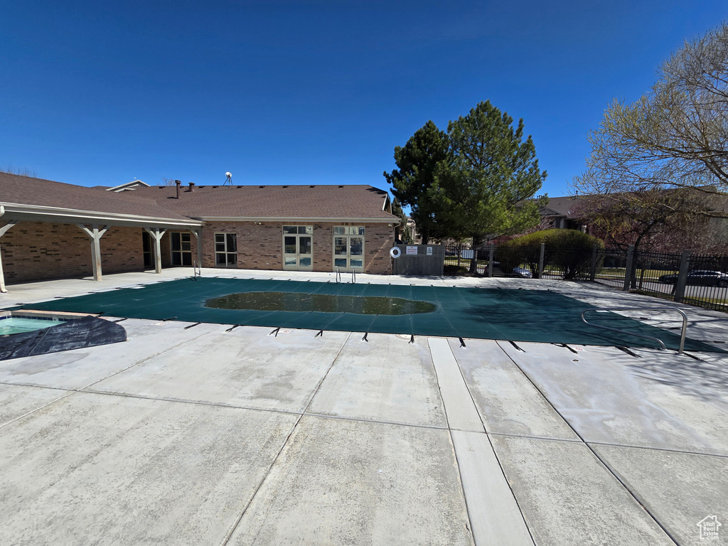 View of pool with fence, a fenced in pool, and a patio