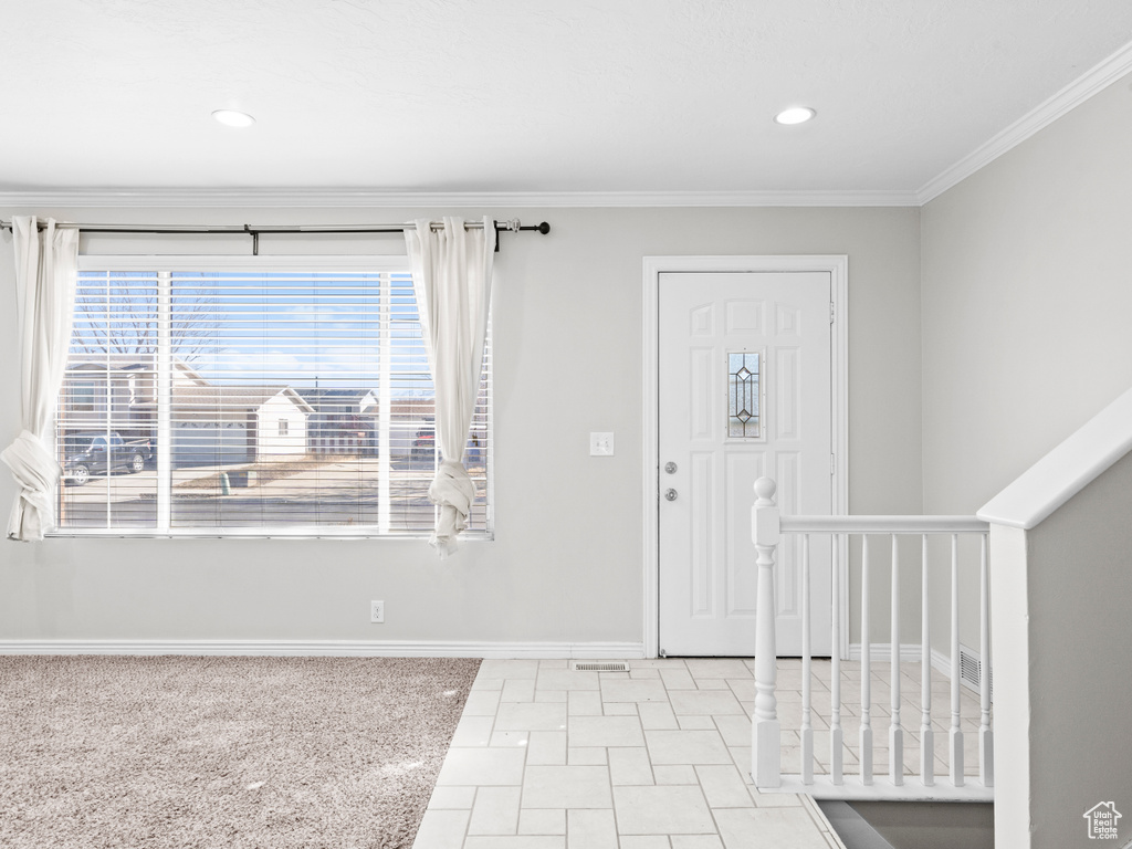 Entrance foyer with ornamental molding, recessed lighting, and baseboards