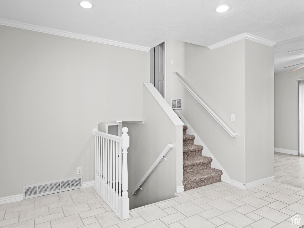 Stairway featuring baseboards, recessed lighting, visible vents, and crown molding