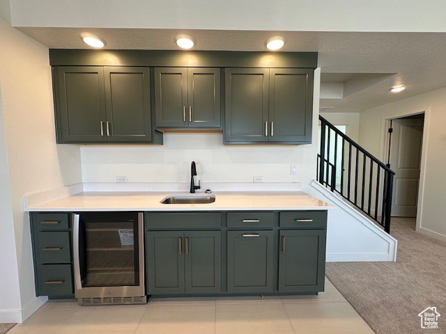 Bar with wine cooler, a sink, baseboards, recessed lighting, and stairway