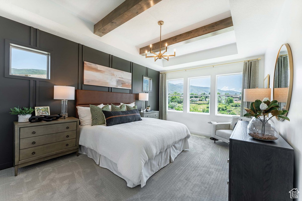 Bedroom with beamed ceiling, baseboards, light colored carpet, and an inviting chandelier