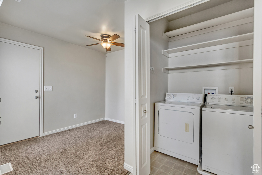Laundry area featuring light carpet, laundry area, baseboards, a ceiling fan, and washer and dryer