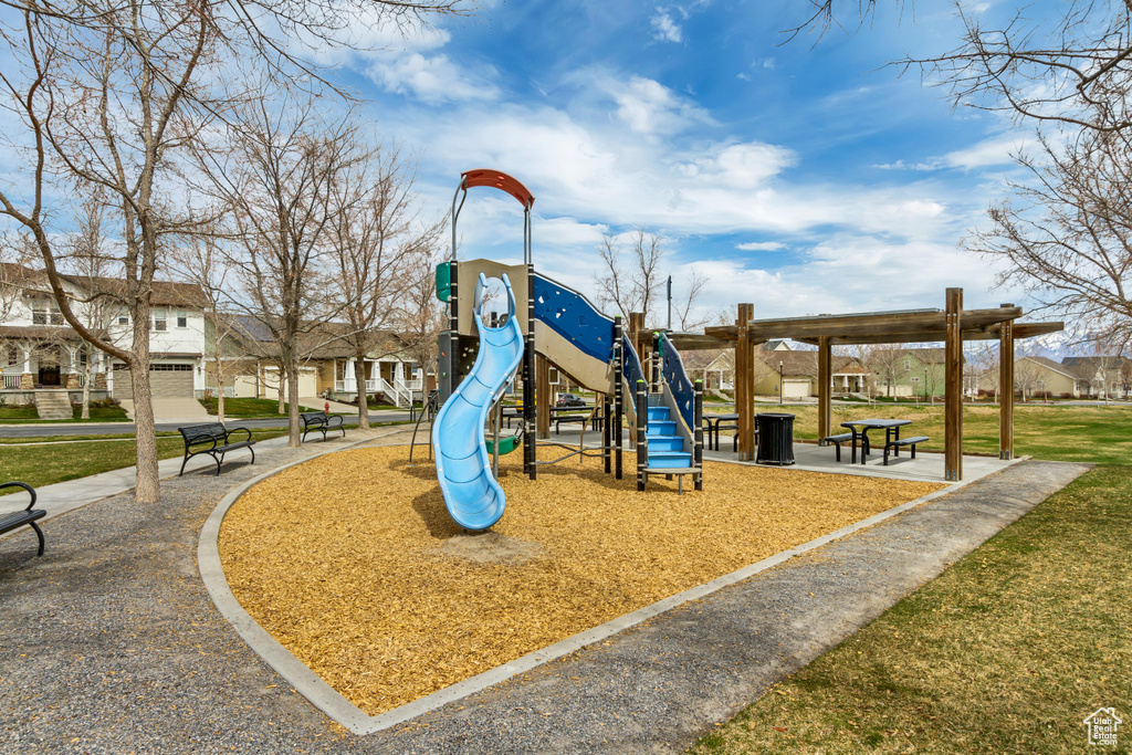 Communal playground with a residential view and a lawn