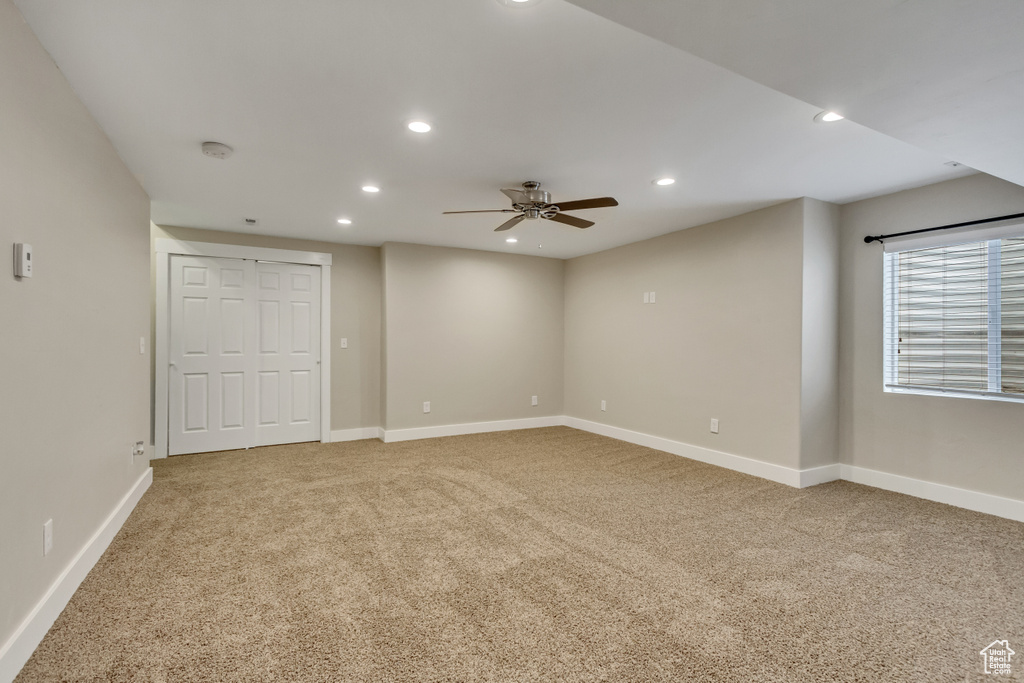 Empty room with recessed lighting, light colored carpet, ceiling fan, and baseboards