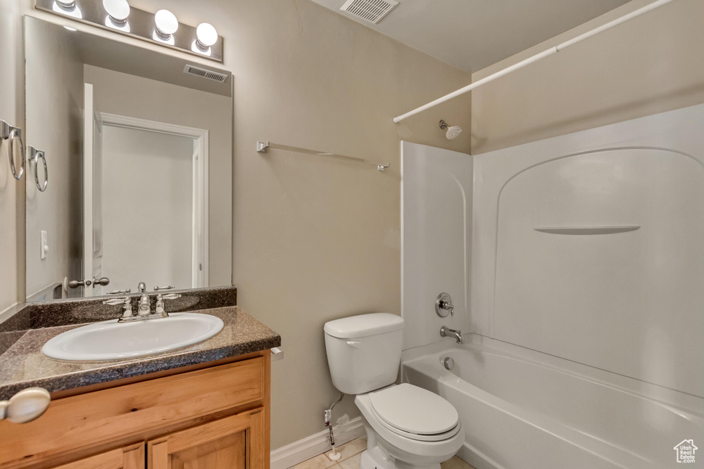 Bathroom featuring visible vents,  shower combination, toilet, and vanity