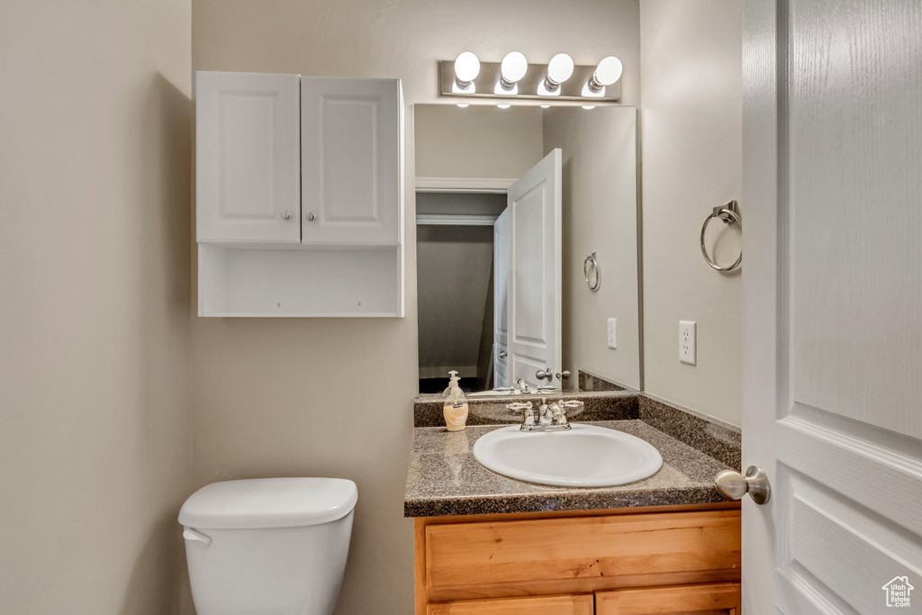 Half bathroom featuring toilet and vanity