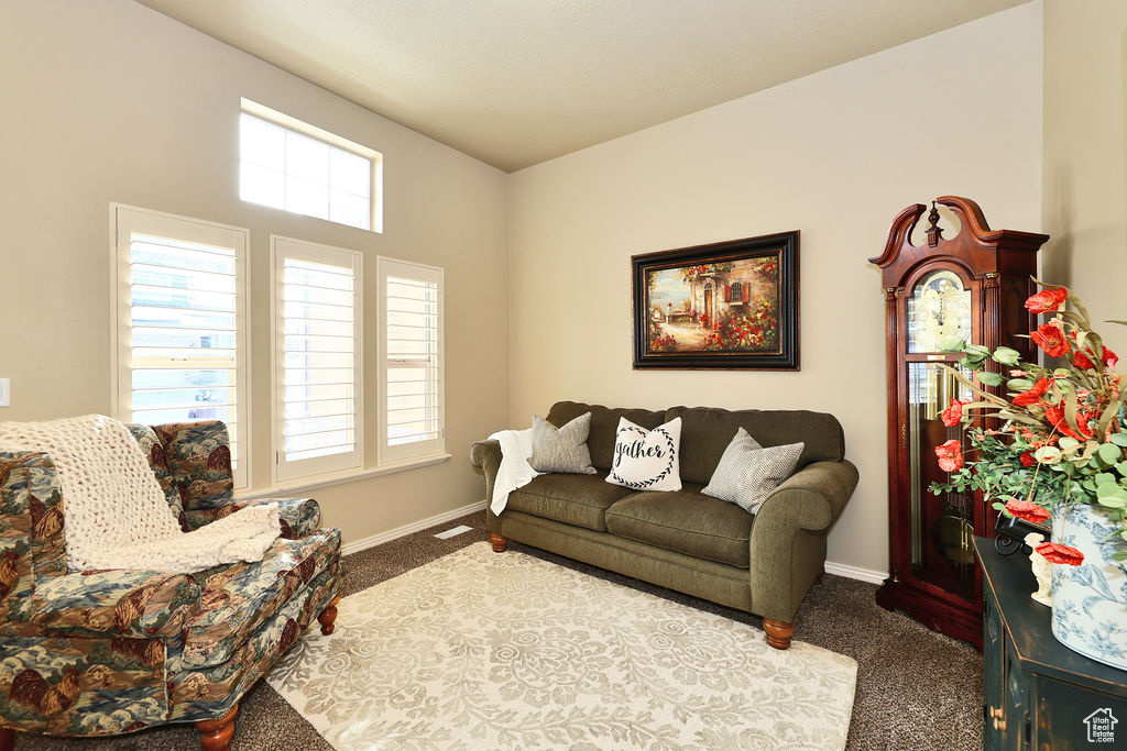 Living room with visible vents, baseboards, and carpet flooring