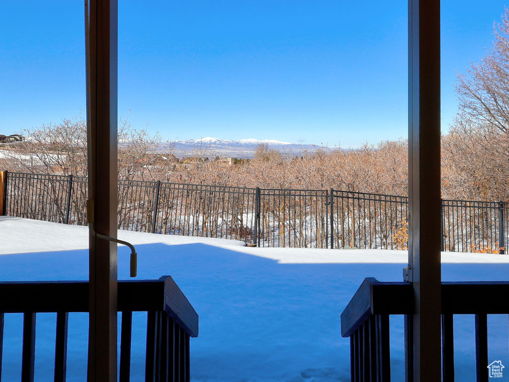 Yard layered in snow with fence