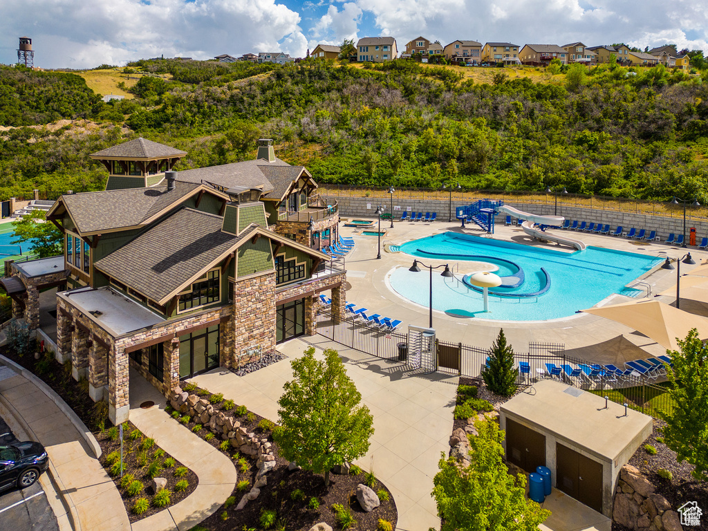 Pool with a patio area and fence