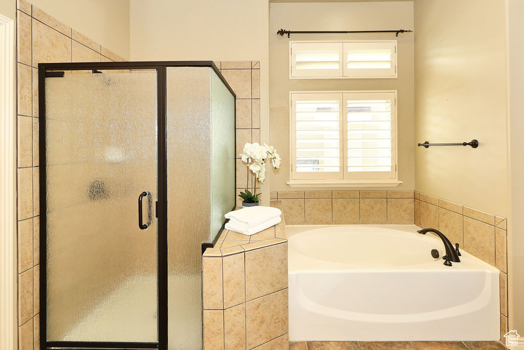 Full bathroom featuring a stall shower and a garden tub