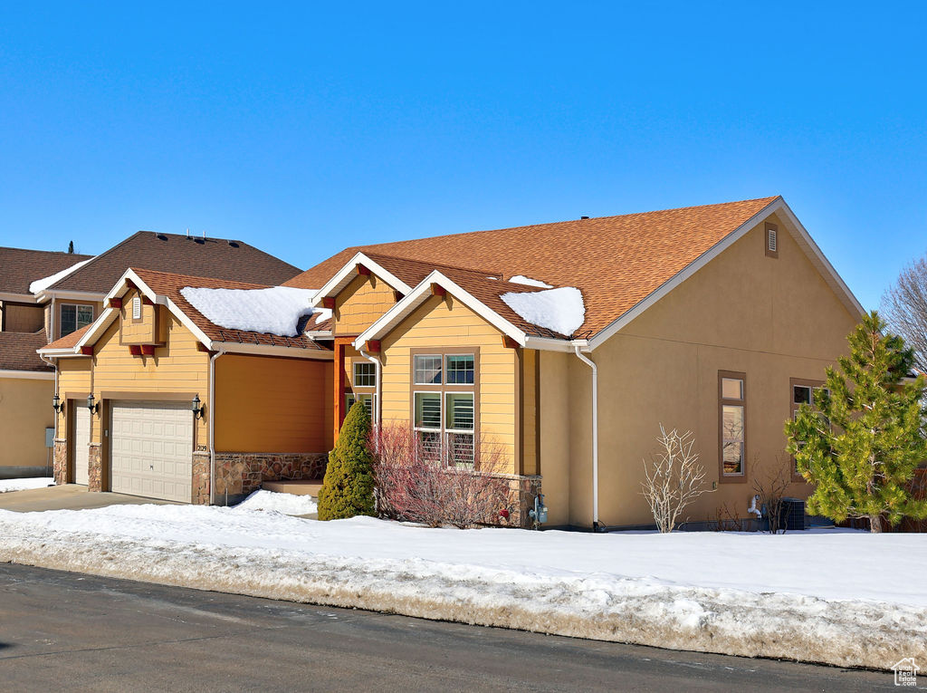 View of front of house featuring a garage and stucco siding