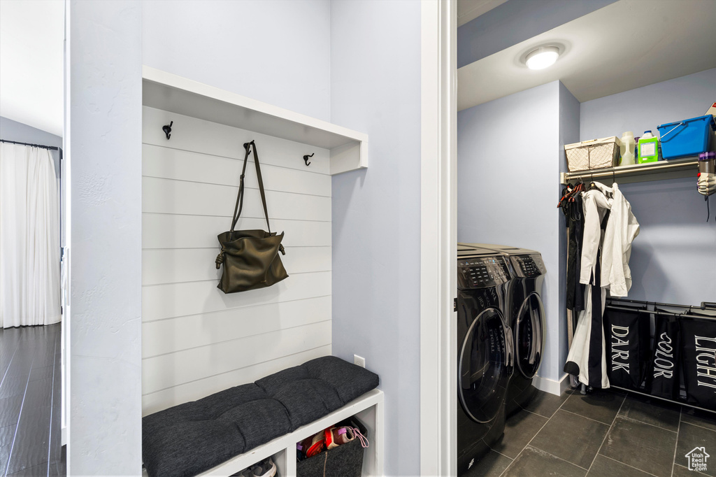 Laundry area featuring laundry area, dark tile patterned flooring, and independent washer and dryer