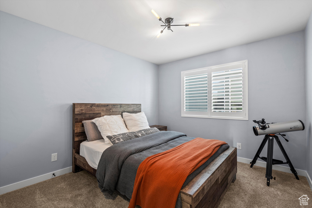 Bedroom with light carpet and baseboards