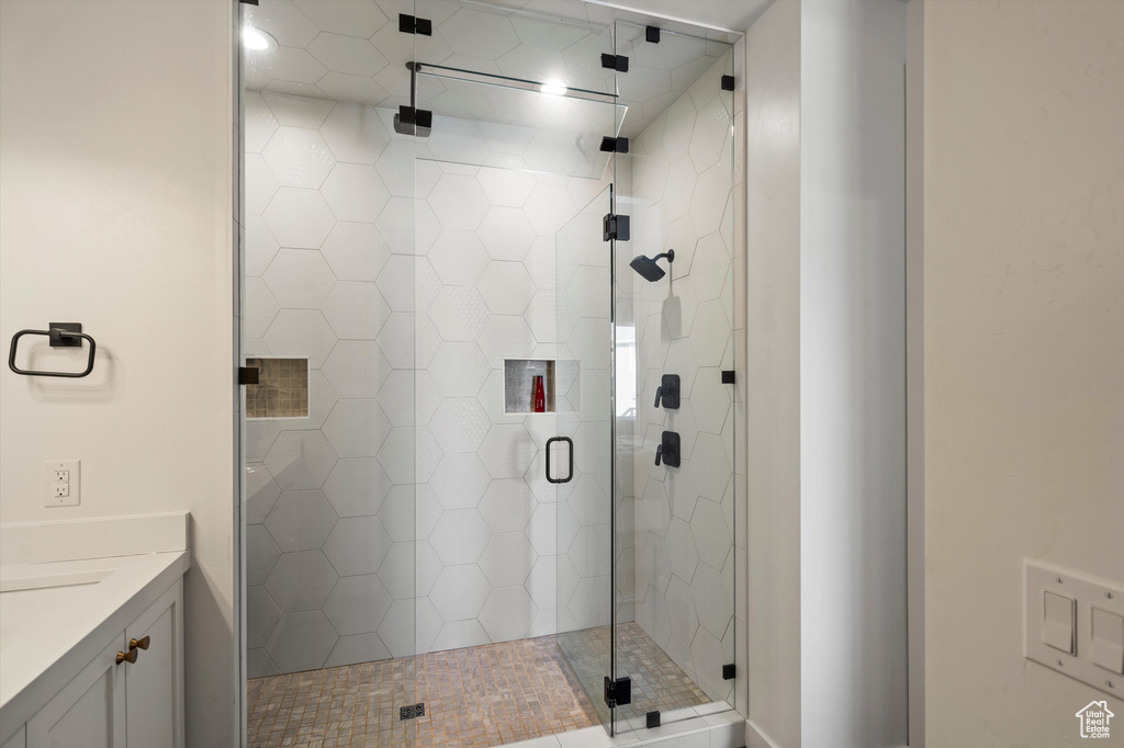 Bathroom featuring a shower stall and vanity