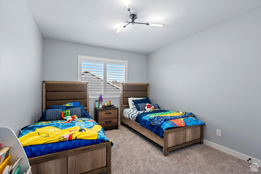 Bedroom featuring carpet flooring and baseboards