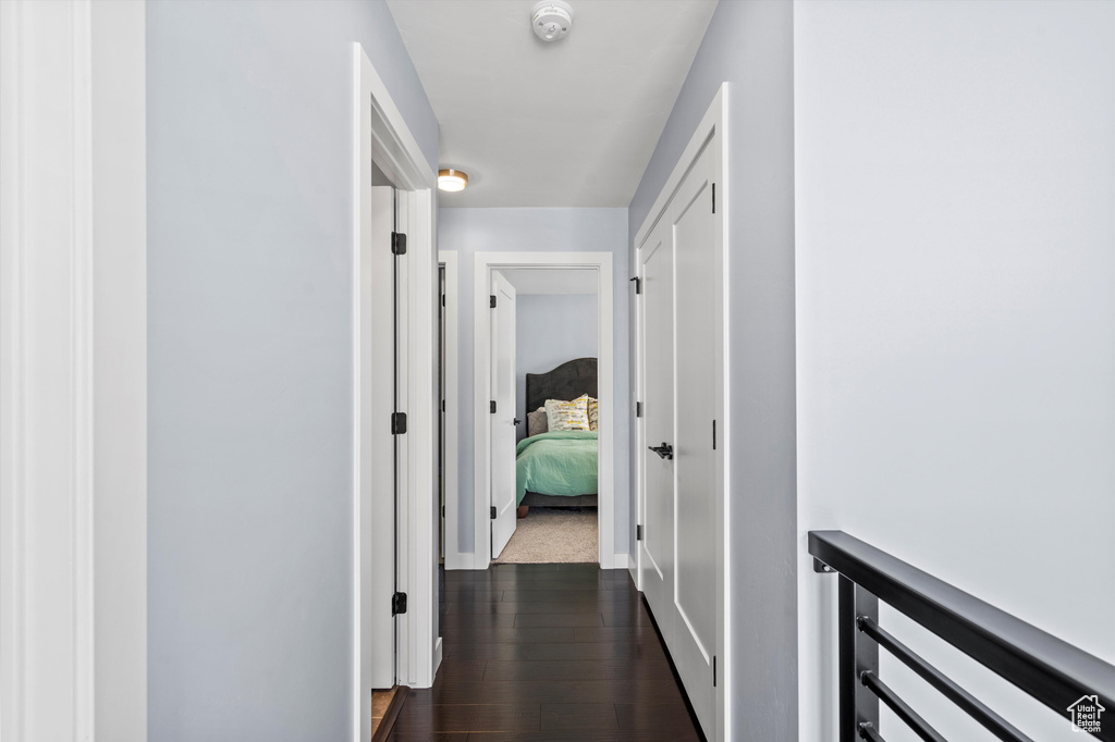 Hallway with dark wood finished floors and baseboards