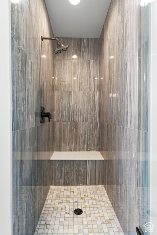 Full bath featuring a tile shower