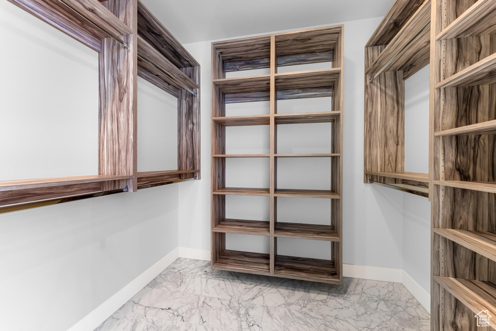 Spacious closet with marble finish floor