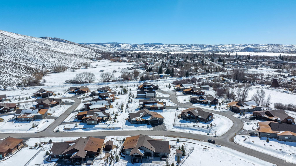 Snowy aerial view with a residential view and a mountain view