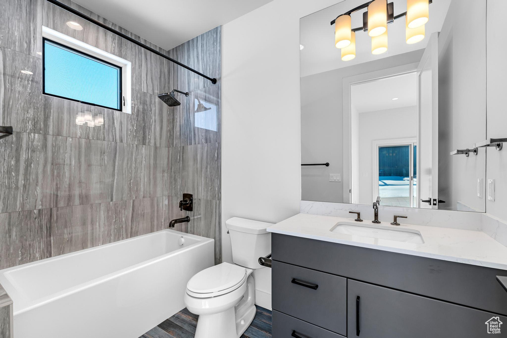Full bathroom featuring toilet, shower / bathing tub combination, wood finished floors, and vanity
