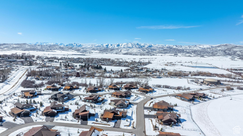 Snowy aerial view with a residential view and a mountain view