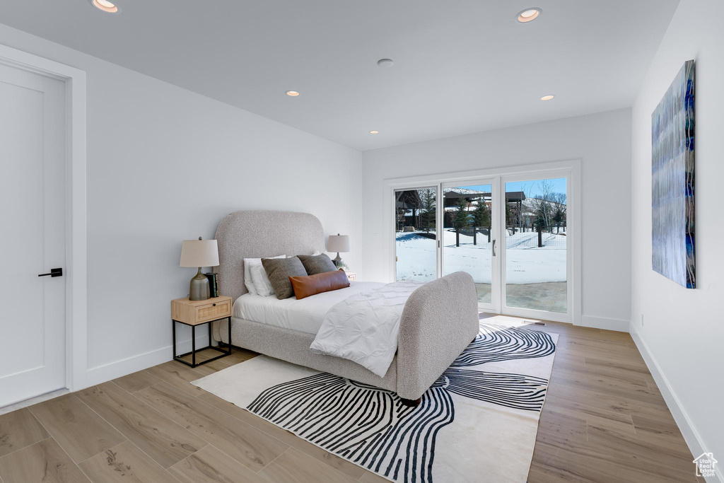 Bedroom with light wood-type flooring, access to outside, baseboards, and recessed lighting