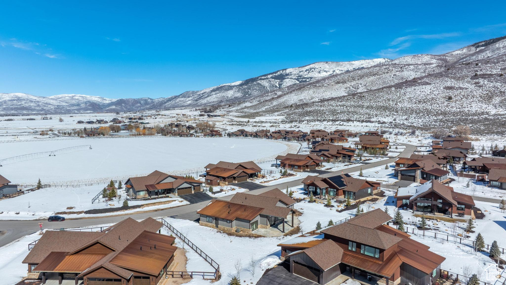 Snowy aerial view featuring a residential view and a mountain view