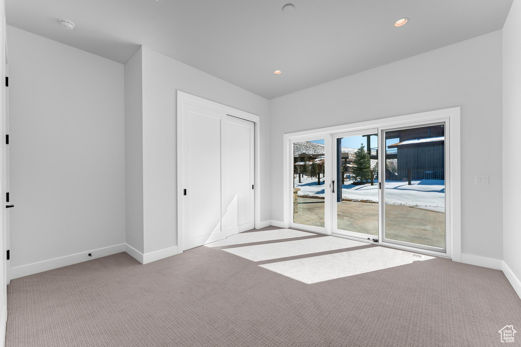 Unfurnished bedroom with recessed lighting, access to outside, baseboards, and light colored carpet