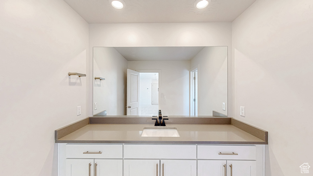 Bathroom featuring recessed lighting and vanity