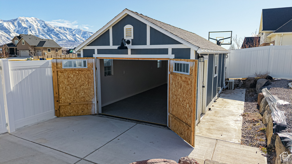 Exterior space featuring fence and a mountain view