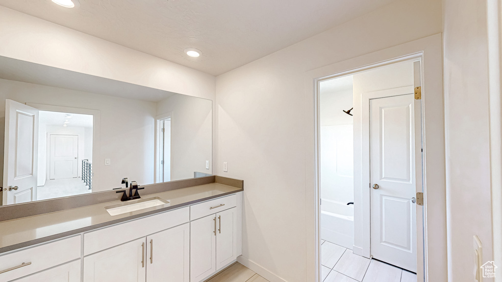 Bathroom with recessed lighting, baseboards, and vanity